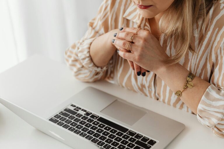Person working on a laptop at a desk.